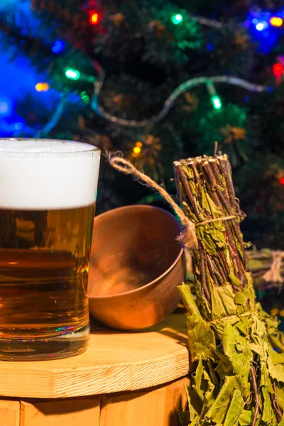 Vertical shot of a glass of beer and birch broom — Stock Photo, Image