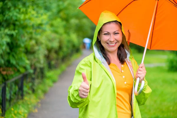 Happy cute girl is showing how she likes rain — Stock Photo, Image