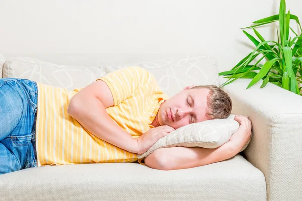 Portrait of a man sleeping on the couch in the living room — Stock Photo, Image