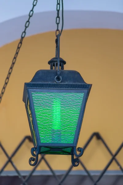 Vintage lantern on the street hanging on a chain — Stock Photo, Image