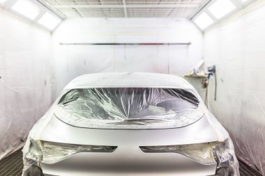 view of an empty car paint booth with the vehicle ready to start painting