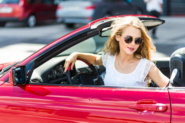 Bella ragazza bionda in una macchina cabriolet rossa — Foto Stock