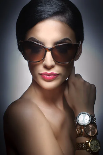 Woman with dark sunglasses and three watches on her arm. Beautiful woman portrait. Fashion art photo of young model with sunglasses. Elegant female portrait isolated. Romantic. Beauty. Modern style — Stock Photo, Image