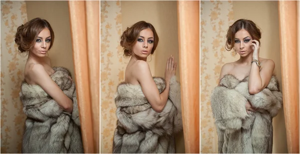 Attractive sexy young woman wearing a fur coat posing provocatively indoor. Portrait of sensual female with creative haircut, studio shot. Beautiful girl covered only with a fur exposing her shoulders — Stock Photo, Image