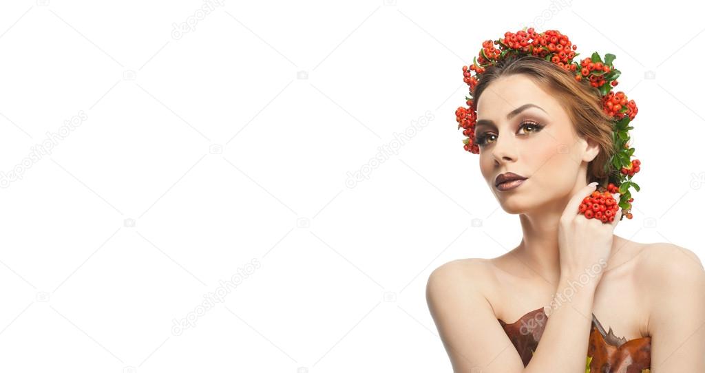 Autumnal woman. Beautiful creative makeup and hair style in fall concept studio shot. Beauty fashion model girl with autumnal make up and hair style. Fall. Creative Autumn makeup. Gorgeous redhead.