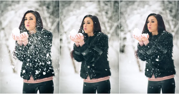 Weergave van gelukkig brunette meisje spelen met sneeuw in de winterlandschap. Mooie jonge vrouw op winter achtergrond. Aantrekkelijke jonge vrouw in warme zachte kleding buiten in een winterdag — Stockfoto