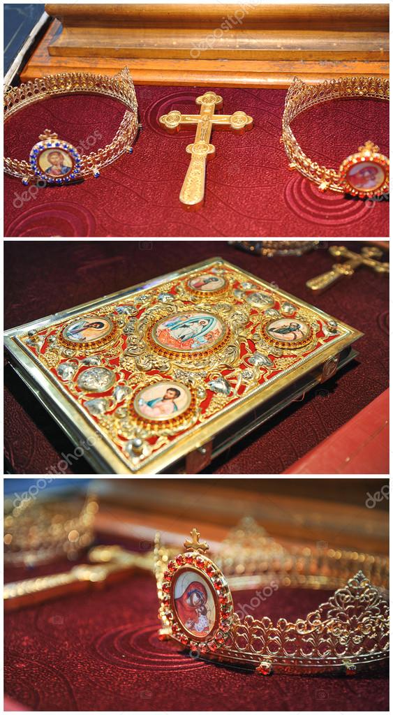 Bible, cross, crowns of gold on the table in church.Wedding celebration