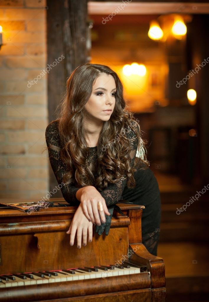 Woman in black long dress over dark background | Stock Photo ... Woman in black long dress over dark background | Stock Photo ...