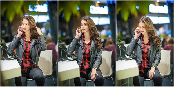 Attractive woman speaking on mobile in mall. Beautiful fashionable young girl in black leather jacket posing in modern shopping center. Casual long hair brunette with red black checkered shirt indoor. — Stockfoto