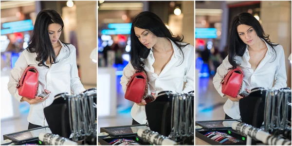 Atractiva joven mujer de moda rodada en el centro comercial. Hermosa joven de moda en camisa blanca en la zona comercial. Casual pelo largo morena recogiendo ropa y accesorios, tiro en el interior —  Fotos de Stock