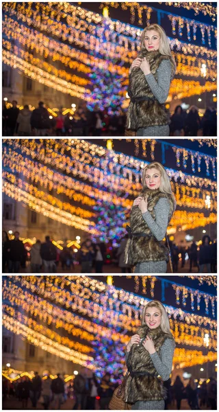 Portret van jonge mooie vrouw met lang eerlijke haar buiten in de koude winteravond. Prachtige blond meisje in winterkleren met kerstverlichting in achtergrond. Mooie vrouw die lacht in winter landschap — Stockfoto