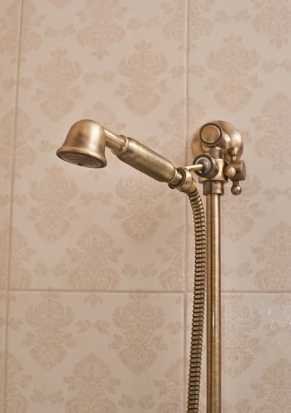 Cabeza de ducha dorada en la pared con valla. Cabeza de ducha Vintage —  Fotos de Stock