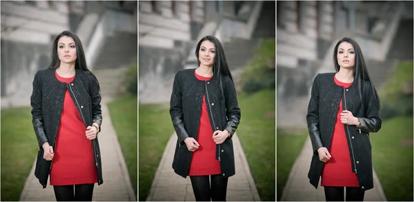 Aantrekkelijke jonge vrouw in winter mode geschoten met Voortbouwend op achtergrond. Mooi modieus meisje in zwarte jas over rode korte jurk lopen op avenue. Elegante lange haren brunette in stedelijke omgeving. — Stockfoto