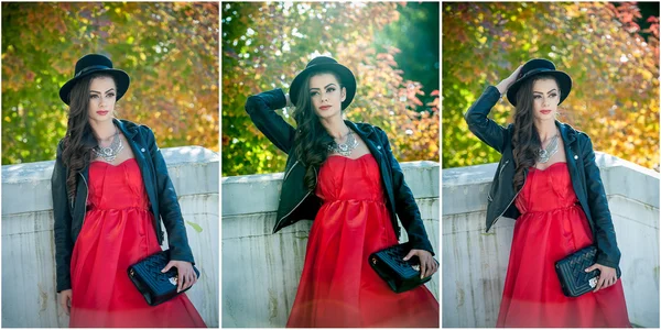 Belle femme avec chapeau noir posant dans le parc automnal. Jeune brune passe du temps en automne en forêt. Fille attrayant cheveux longs avec maquillage créatif et robe rouge, en plein air tourné pendant l'automne — Photo