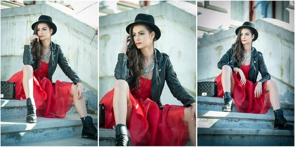 Hermosa mujer con sombrero negro, vestido rojo y botas posando sentado en las escaleras. Joven morena pasando tiempo durante el otoño. Chica atractiva pelo largo con maquillaje creativo y vestido rojo, tiro al aire libre — Foto de Stock