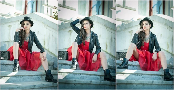 Hermosa mujer con sombrero negro, vestido rojo y botas posando sentado en las escaleras. Joven morena pasando tiempo durante el otoño. Chica atractiva pelo largo con maquillaje creativo y vestido rojo, tiro al aire libre — Foto de Stock