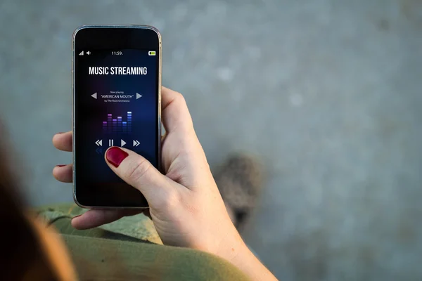 Woman using phone with music streaming — Stock Photo, Image