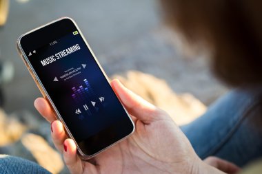 smartphone akarsu müzik ile tutan kadın