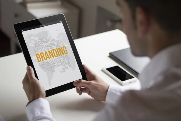 Business man branding with tablet pc — стоковое фото