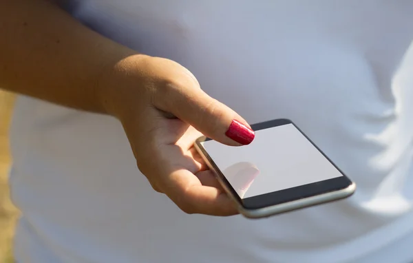 Woman touching screen of white smartphone — Stock Photo, Image