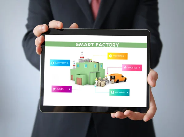 Businessman with smart factory on a tablet — Stock Photo, Image