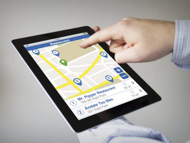 hands holding touchscreen tablet