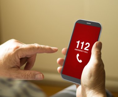 man dialing emergencies number