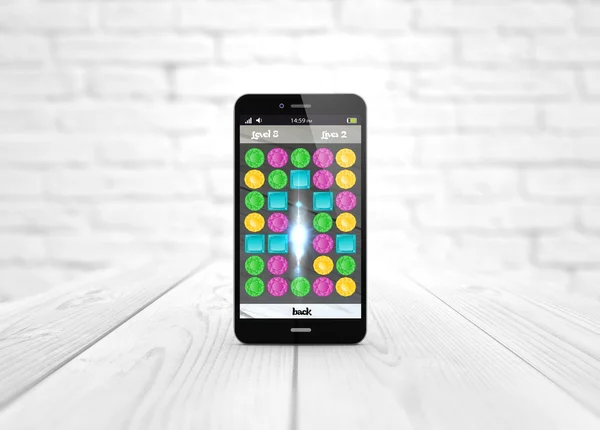 Игровой смартфон на белом деревянном фоне — стоковое фото