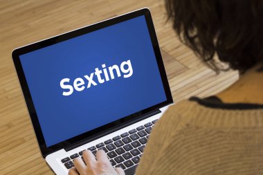 women using sexting on laptop clipart
