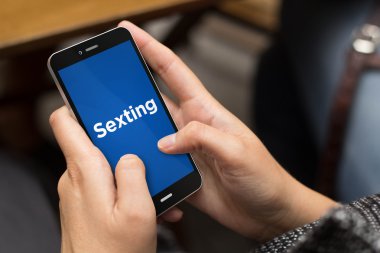 girl using smartphone for sexting clipart