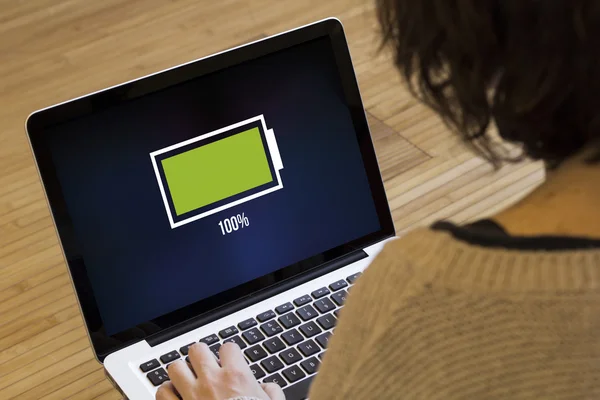 Woman with computer full battery — Stock Photo, Image