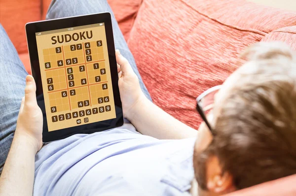 Sudoku uygulama tablet üzerinde oynarken hipster — Stok fotoğraf