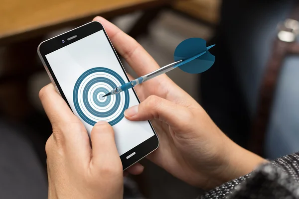 Girl using smartphone with target on the screen — Stock Photo, Image
