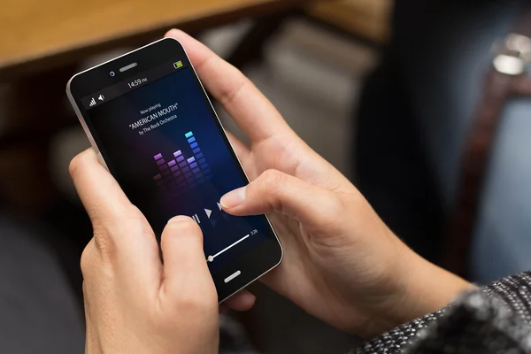 Girl using smartphone with music app — Stock Photo, Image