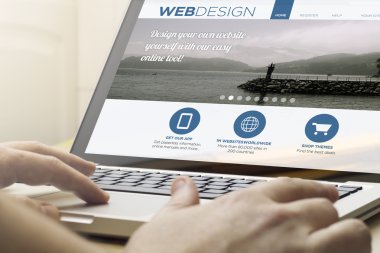 man using a laptop with webdesign on the screen