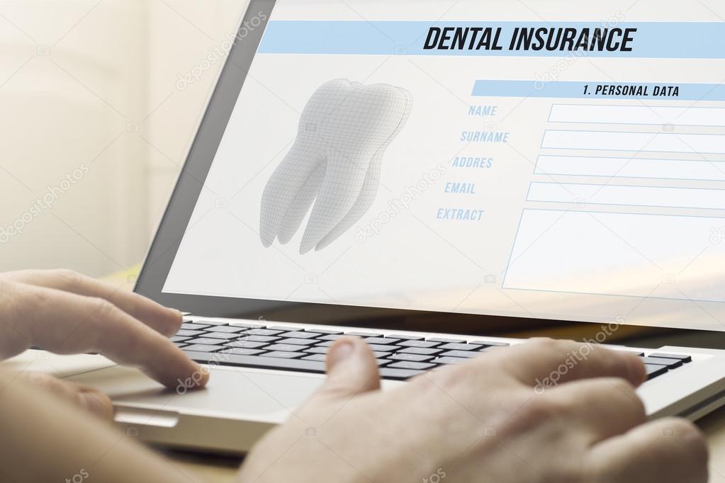 man using a laptop with dental insurance