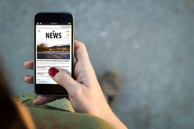 Woman walking with smartphone reading news