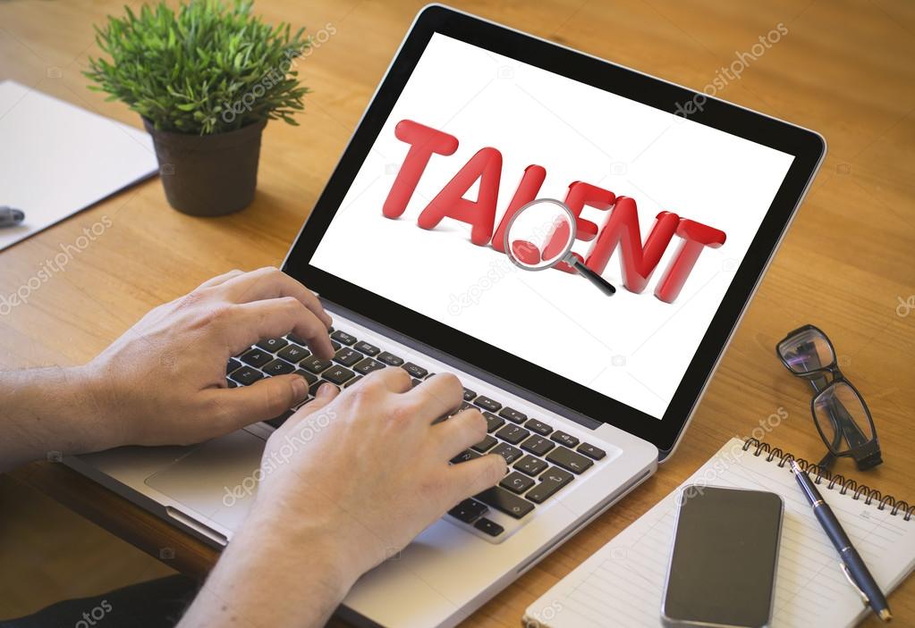 man working on laptop using talent search