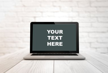 computer on a table your text here