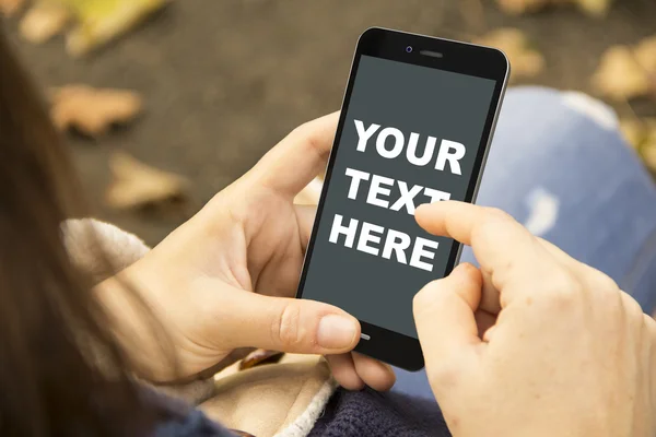 Woman with mock-up  phone in the park — Stock Photo, Image