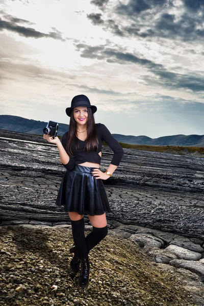 Sexy photographer on mud volcanoes landscape Stock Image