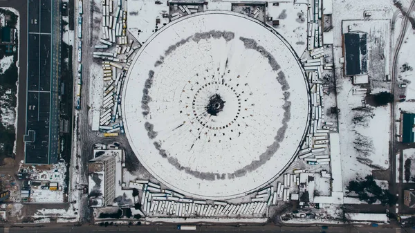 Top view aerial shot of famous Kyiv abandoned round bus park covered wtih snow, Ukraine