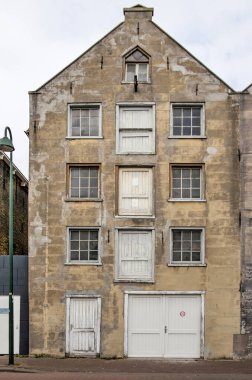 Masssluis, Hollanda, 12 Haziran 2021: Sarımsı kahverengi kumtaşından yapılmış ön cepheli İç Liman 'a bakan eski bir depo