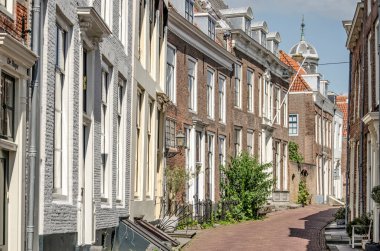 Middelburg, the Netherlands, July 25, 2021: picturesque street with brick facades in the old town on a sunny day