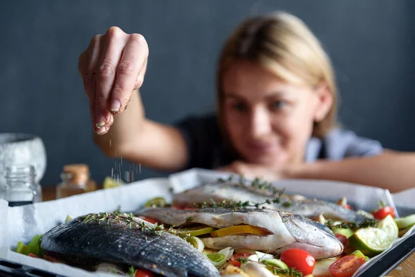 chef woman cooks fish