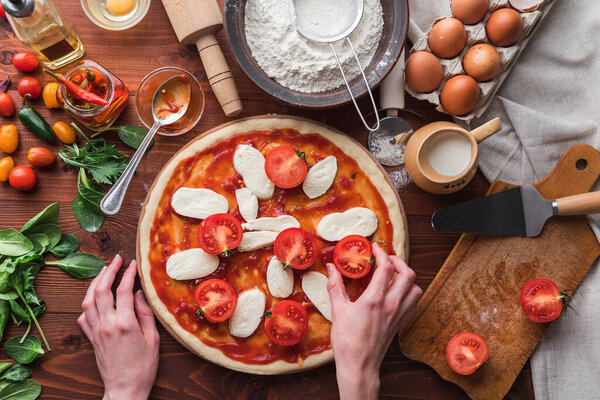 Step-by-step boss makes a pizza margarita. Dough and pizza ingredients