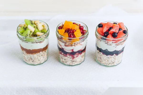 Oatmeal with fruit and cereals in a glass jar