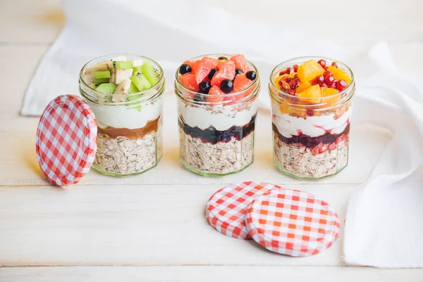 Oatmeal with fruit and cereals in a glass jar