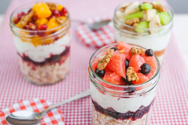 Oatmeal with fruit and cereals in a glass jar