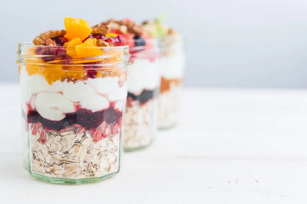 Oatmeal with fruit and cereals in a glass jar